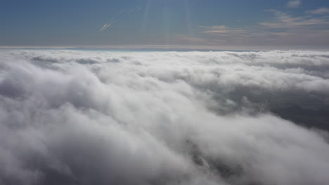 Above-clouds-moving-fast-windy-day-sunny-blue-sky-France